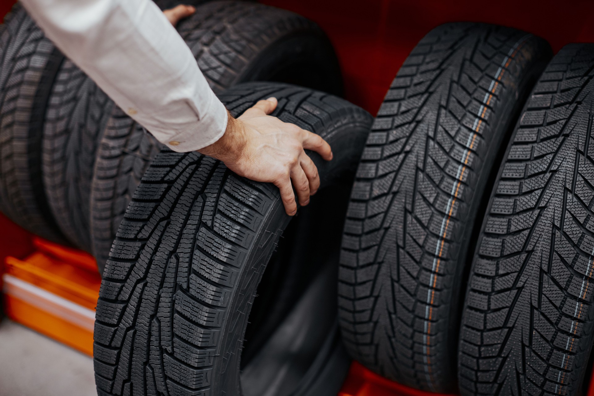 close-up of a man's hand with car tires